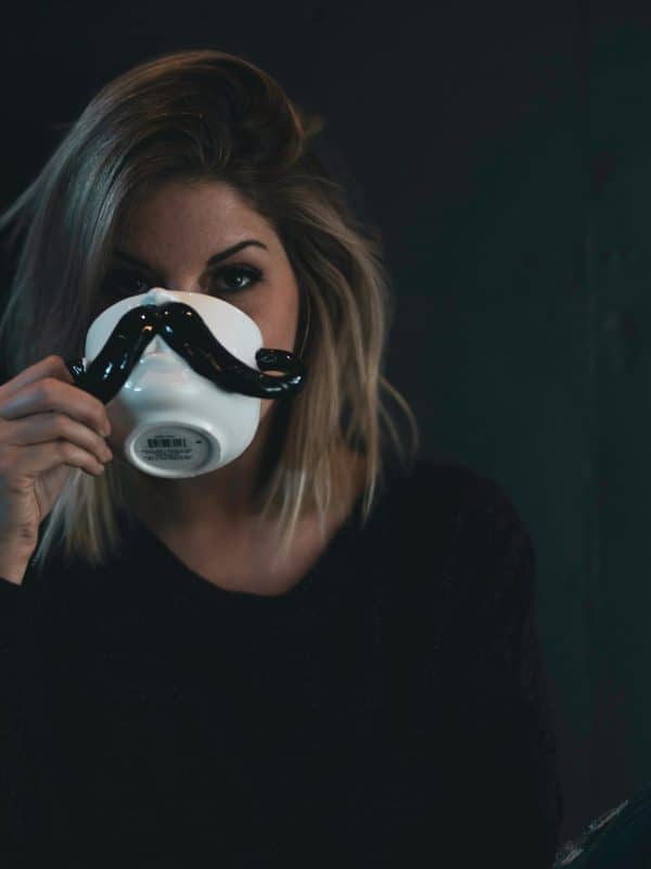 woman drinking from a mustasch cup